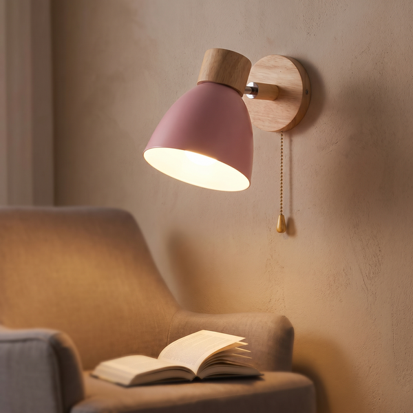 Wooden Nordic Wall Sconce lit above a reading chair