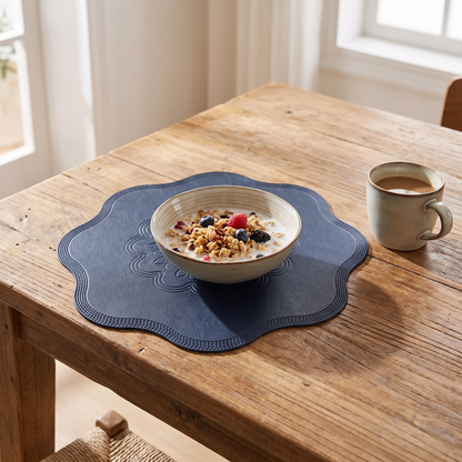 Round Faux Leather Placemat with embossed flower design on a breakfast table